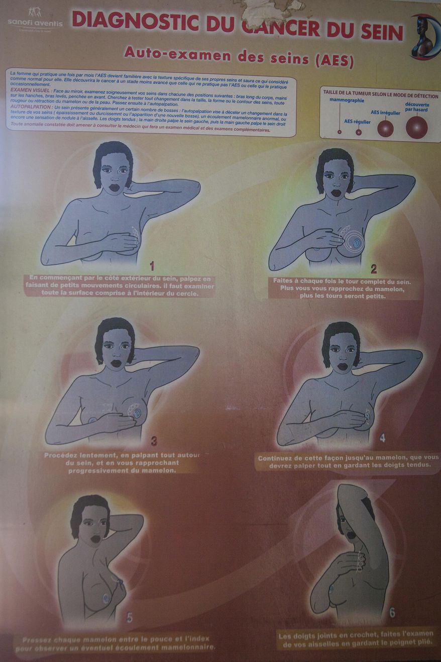 A chart shows how to perform a breast examination on oneself at the Clinique des Mamelles in Dakar, Senegal, Thursday, July 13, 2017. The word cancer is rarely spoken in Senegal, synonymous with death in a country where many are only diagnosed in the later stages of disease and radiation therapy can be difficult to access. Cancer has become an emerging public health problem in West Africa, and the lack of strong prevention, good screening and treatment often leaves outcomes grim. (AP Photo/Jane Hahn)