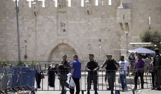 Israeli border police officers stand guard outside the Damascus Gate in Jerusalem&#x27;s Old City, Saturday, July 15, 2017. On Friday, three Palestinian assailants opened fire from a sacred site inside the Old City, known to Muslims as the Noble Sanctuary and to Jews as the Temple Mount, killing two Israeli police officers before being shot dead. (AP Photo/Mahmoud Illean)