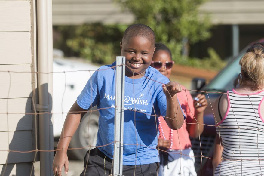 ADVANCE FOR USE SATURDAY, JULY 15 - In this Thursday, July 6, 2017 photo, Craig Randle Jr. smiles as he returns from a trip to Disney World to find his family&#39;s home renovated  in Poulsbo, Wash. (Michaela Roman/Kitsap Sun via AP)