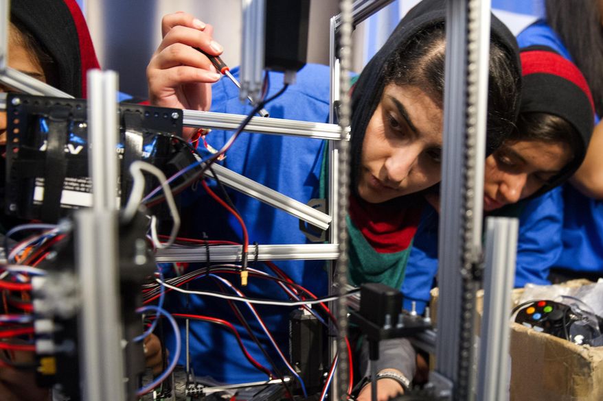 Afghanistan team member Lisa Azizi trouble shoots the teams robot entry prior to the opening ceremony for the FIRST Global Challenge 2017, in Washington, Sunday, July 16, 2017. They will be competing against entrants from more than 150 countries in the FIRST Global Challenge. It’s the first annual robotics competition designed to encourage youths to pursue careers in math and science. (AP Photo/Cliff Owen)