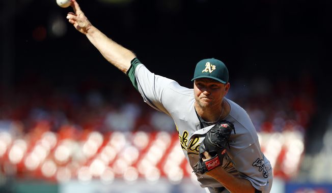 FILE - This Aug. 28, 2016 file photo shows Oakland Athletics relief pitcher Ryan Madson throwing during the ninth inning of a baseball game against the St. Louis Cardinals in St. Louis. The Washington Nationals acquired Madson and reliever Sean Doolittle from the Oakland Athletics for right-hander Blake Treinen and a pair of prospects, Sunday, July 16, 2017. (AP Photo/Billy Hurst, file)