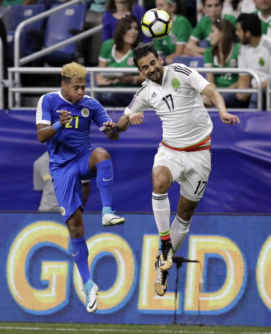 Curacao's Ayrton Statie (21) and Mexico's Raul Lopez (17) leap for a header during a CONCACAF Gold Cup soccer match in San Antonio, Sunday, July 16, 2017. (AP Photo/Eric Gay)