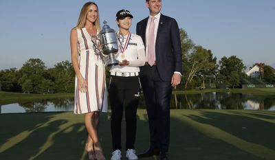 South Korea&#39;s Sung Hyun Park, center, poses for a photo with Eric Trump, right, and Trump&#39;s wife Lara Yunaska after winning the U.S. Women&#39;s Open Golf tournament, Sunday, July 16, 2017, in Bedminster, N.J. (AP Photo/Seth Wenig)