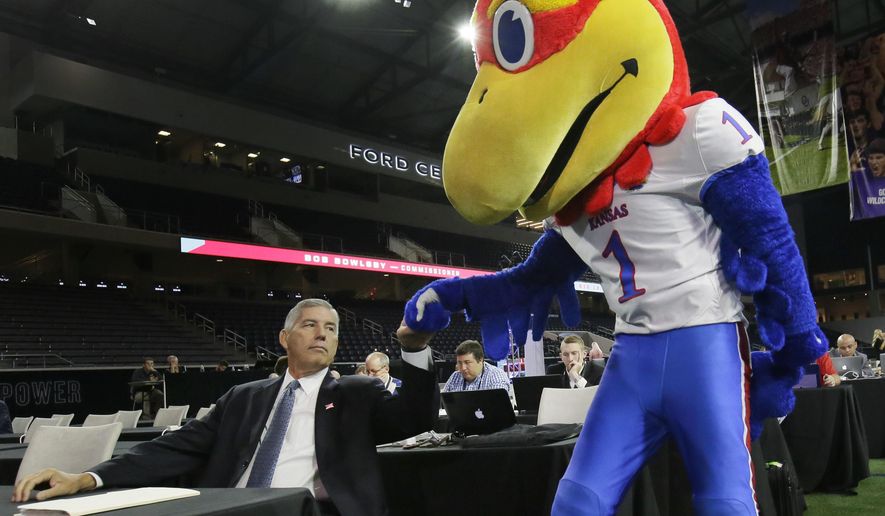 Big 12 commissioner Bob Bowlsby fist bumps the Kansas Jayhawks mascot before speaking to reporters during the Big 12 NCAA college football media day in Frisco, Texas, Monday, July 17, 2017. (AP Photo/LM Otero) ** FILE **