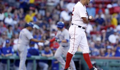 Boston Red Sox starting pitcher Eduardo Rodriguez, right, walks to the mound with a fresh baseball as Toronto Blue Jays&#39; Steve Pearce rounds the bases on a solo home run during the second inning of a baseball game at Fenway Park in Boston, Monday, July 17, 2017.(AP Photo/Charles Krupa)