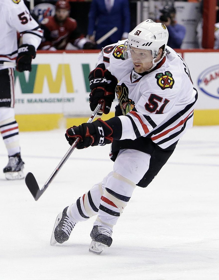 FILE - In this Feb. 2, 2017, file photo, Chicago Blackhawks defenseman Brian Campbell (51) shoots in the first period during an NHL hockey game against the Arizona Coyotes, in Glendale, Ariz. Defenseman Brian Campbell is retiring at age 38 after playing 17 NHL seasons and winning the Stanley Cup with the Chicago Blackhawks in 2010. Campbell announced his retirement Monday, July 17, 2017. (AP Photo/Rick Scuteri, File)