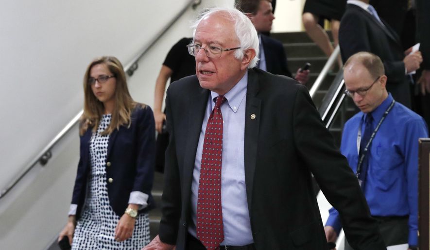 FILE - In this July 11, 2017, file photo, Sen. Bernie Sanders, I-Vt. rides an escalator on Capitol Hill in Washington. Republicans are fending off questions about Russia and the Trump campaign, and dealing with an unpopular health care plan. But Democrats have yet to unify behind a clear, core message that will help them take advantage of their opponents' struggles. (AP Photo/Jacquelyn Martin, File)