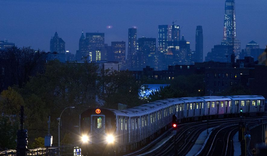 FILE - In this May 11, 2016, file photo, a No. 7 subway train rides the rails in the Queens borough of New York, with the Manhattan skyline in the background. On Monday, July 17, 2017, the Federal Reserve of New York releases its July survey of manufacturers in the state. (AP Photo/Mark Lennihan, File)