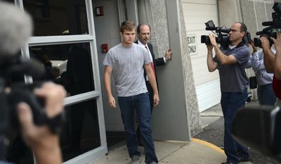 FILE - In this Aug. 16, 2013, file photo, Speck Mellencamp, center, leaves the Monroe County Jail after being booked in and bonded out of jail in Bloomington, Ind. Police say 22-year-old Mellencamp, a son of rock star John Mellencamp, was arrested early Sunday, July 16, 2017, after he and his 23-year-old brother, Hud, were involved in a fight outside a Bloomington restaurant. (Chris Howell/The Herald-Times via AP, File)