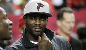 In this Jan. 1, 2017, file photo, former Atlanta Falcons quarterback Michael Vick stands on the sidelines before NFL football game between the Falcons and the New Orleans Saints in Atlanta. Vick told Fox Sports 1 Monday, July 17, 2017, that former San Francisco 49ers quarterback Colin Kaepernick should get a haircut in order to &amp;quot;try to be more presentable&amp;quot; as he searches for another NFL job. (AP Photo/John Bazemore, File) **FILE**