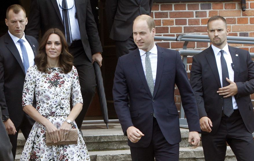 Britain's Prince William, center, and Kate, the Duchess of Cambridge walk through the grounds of the former Nazi concentration camp Stutthof near the town of Sztutowo, 30 kilometers east of the city of Gdansk, Poland, Tuesday, July 18, 2017. The royal couple visited a World War II Nazi German concentration camp and tour the picturesque city of Gdansk in northern Poland on the second day of a goodwill trip aimed at underscoring Britain's intention to maintain friendly relations with the European Union after it leaves the bloc. (AP Photo/Czarek Sokolowski)