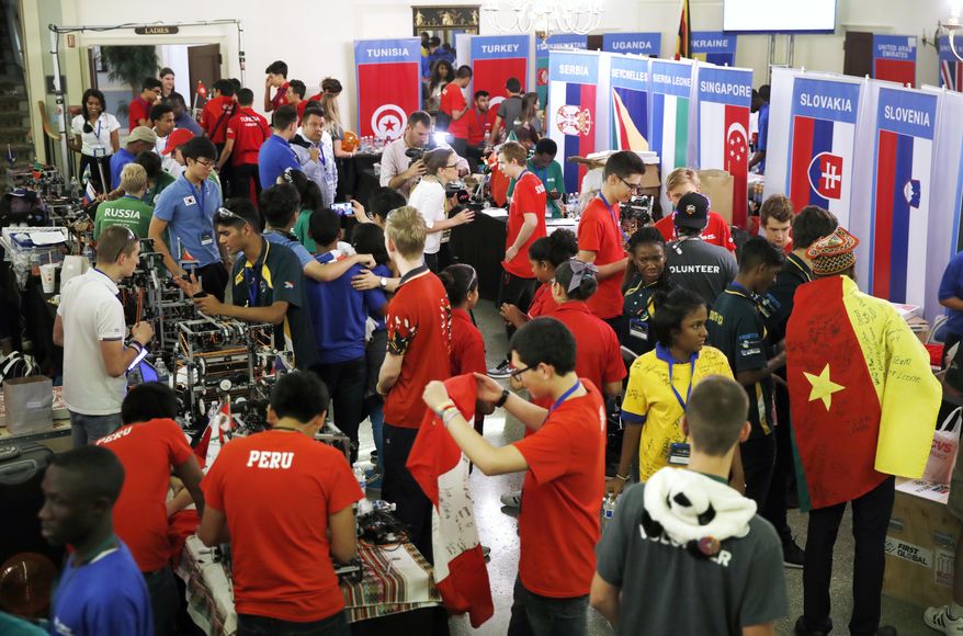 Students from across the world, from Peru, to Russia, to Slovenia, and from across the African continent, meet during the FIRST Global Robotics Challenge, Tuesday, July 18, 2017, in Washington. The challenge is an international robotics event with teams from over 100 countries. (AP Photo/Jacquelyn Martin)