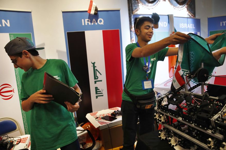 Poriya Mizbani, 16, left, and Amin Dadkhah Tehrani, 15, with Team Iran, begin to pack up their station after competing in the FIRST Global Robotics Challenge, Tuesday, July 18, 2017, in Washington. The challenge is an international robotics event with teams from over 100 countries. (AP Photo/Jacquelyn Martin)