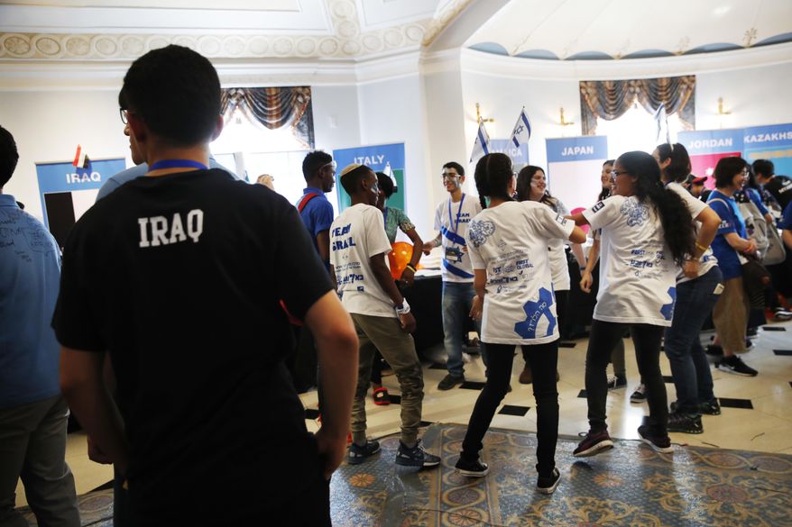 Students from Team Israel dance in the hallway next to other teams including students from Iraq during the FIRST Global Robotics Challenge, Tuesday, July 18, 2017, in Washington. The challenge is an international robotics event with teams from over 100 countries. (AP Photo/Jacquelyn Martin)