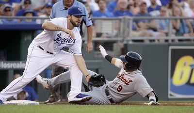 Detroit Tigers&#39; Nicholas Castellanos (9) beats the tag at third by Kansas City Royals third baseman Mike Moustakas after hitting a two-run triple during the second inning of a baseball game Tuesday, July 18, 2017, in Kansas City, Mo. (AP Photo/Charlie Riedel)