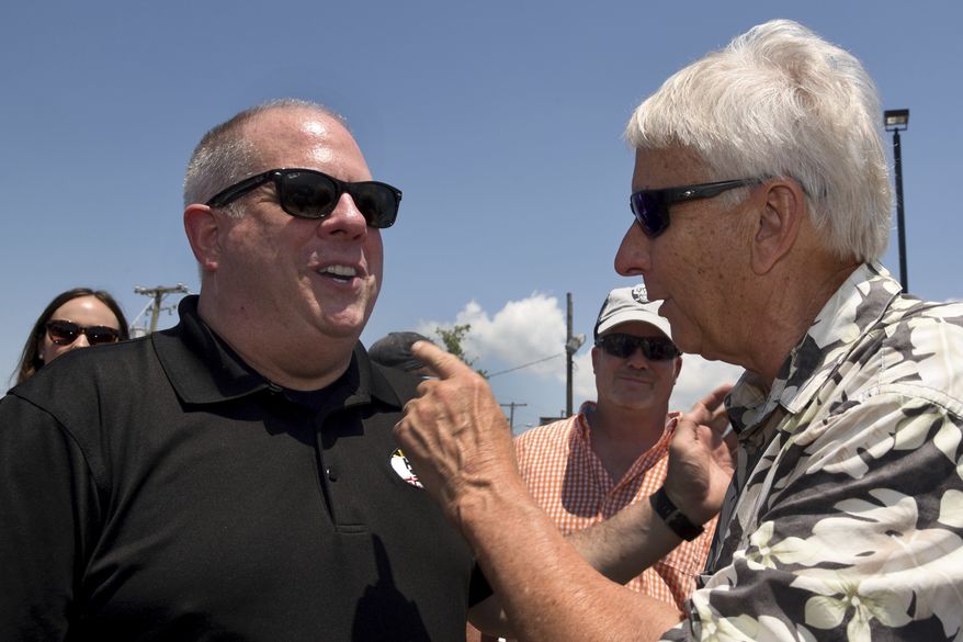 Gov. Larry Hogan is greeted by Jay Tawes, the grandson of Gov. J. Millard Tawes, at the 41st annual J. Millard Tawes Crab and Clam Bake in Crisfield, Md., Wednesday, July 19, 2017. (Amy Davis/The Baltimore Sun via AP)