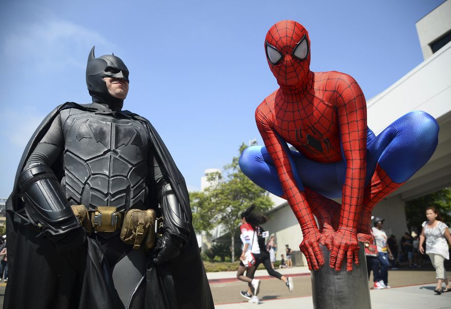 FILE - In this July 23, 2016 file photo, Dorian Black, left, dressed as Batman and Kyle Blankenfield, dressed as Spider-Man appear outside during Comic-Con International in San Diego. The annual pop-culture celebration kicks off Wednesday night with a preview of the San Diego Convention Center’s showroom floor. Four days of panels, presentations, screenings and autograph signings begin on Thursday. (Photo by Al Powers/Invision/AP, File)