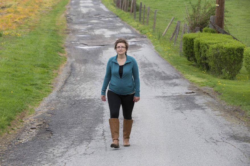 ADVANCE FOR USE SATURDAY, JULY 22, AND THEREAFTER – In this April 21, 2017 photo, Melissa Smith, recovering from a self-inflicted gunshot wound to the head, walks near her home in Wrightsville, Pa. After Smith, depressed and estranged from her husband, put a gun to her head and fired on Oct. 17, 2016, she was flown to Penn Presbyterian Medical Center in Philadelphia. Smith and her mother are telling her story to encourage others suffering from depression and anxiety to seek help. (Jessica Griffin/The Philadelphia Inquirer via AP)