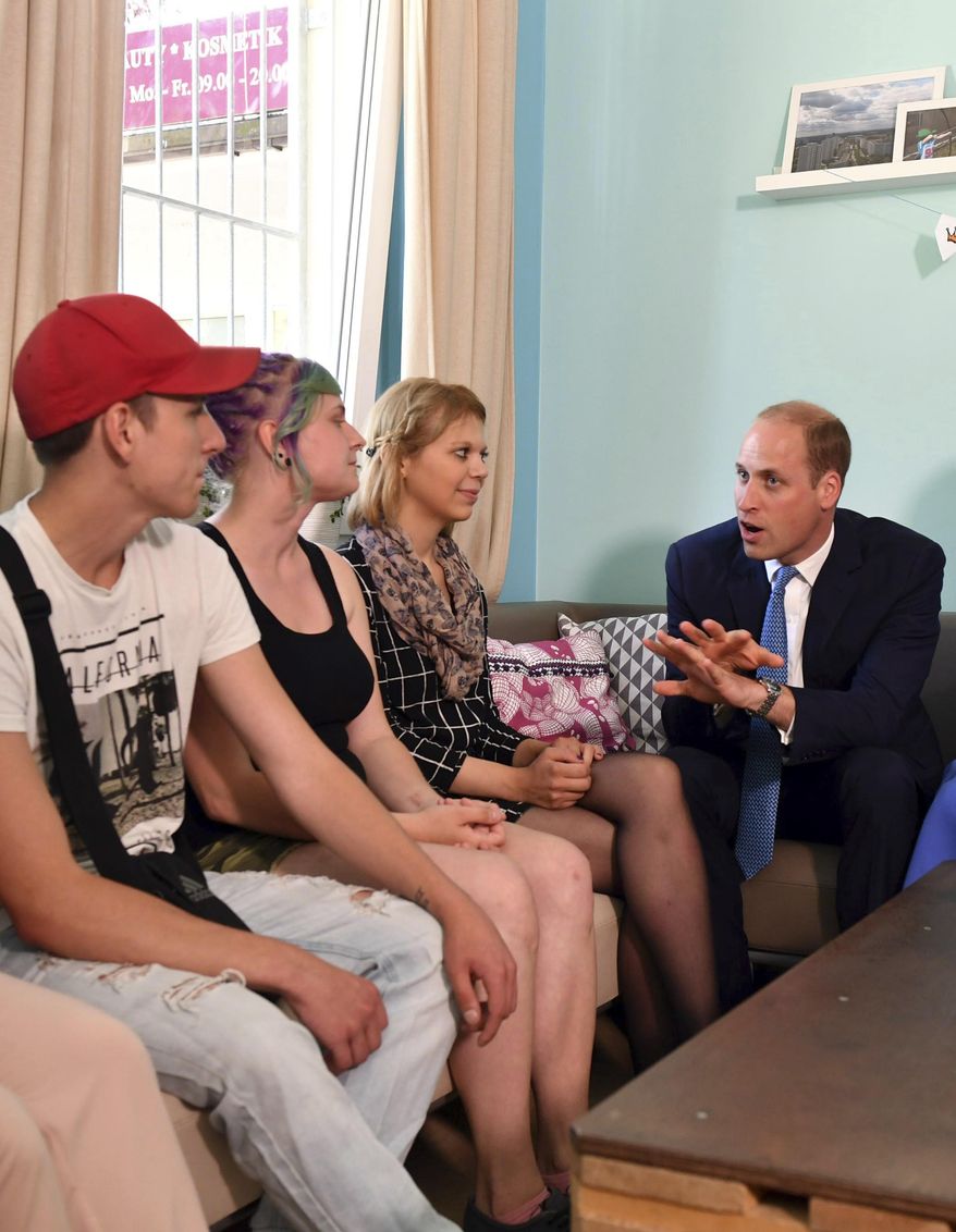 Britain's Prince William, right, talks to adolescents in the Bolle children's and youth centre in Berlin, Germany, Wednesday July 19, 2017. (Britta Pedersen/dpa via AP)