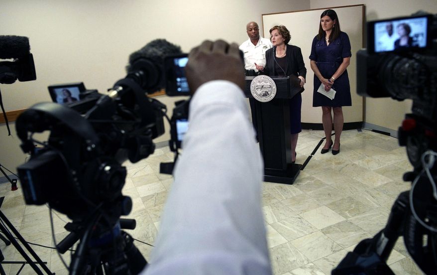 Mayor Betsy Hodges, center, and Assistant Police Chief Medaria Arradondo, left, address the latest developments in the death of Justine Damond, Tuesday, July 18, 2017, in Minneapolis, Minn. Damond, of Australia, was shot and killed on Saturday, July 15 by a Minneapolis police officer after she called 911 to report what she believed to be a possible assault. (Richard Tsong-Taatarii/Star Tribune via AP)