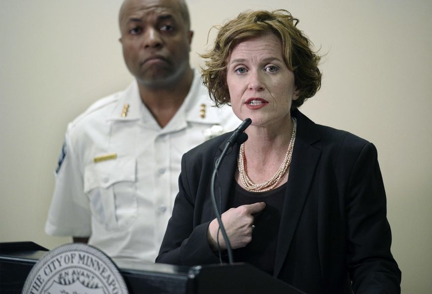 Mayor Betsy Hodges and Assistant Police Chief Medaria Arradondo address the latest developments in the death of Justine Damond, Tuesday, July 18, 2017, in Minneapolis, Minn. Damond, of Australia, was shot and killed on Saturday, July 15 by a Minneapolis police officer after she called 911 to report what she believed to be a possible assault. (Richard Tsong-Taatarii/Star Tribune via AP)