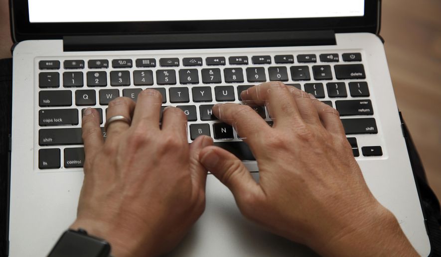 FILE - In this June 19, 2017 file photo, a person works on a laptop in North Andover, Mass. Mexican authorities say the U.S. Department of Homeland Security has instituted heightened security measures for laptops and tablets on U.S.-bound flights from Mexico, starting Wednesday, July 19, 2017. (AP Photo/Elise Amendola, File)