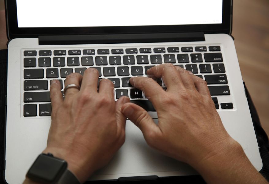 FILE - In this June 19, 2017 file photo, a person works on a laptop in North Andover, Mass. Mexican authorities say the U.S. Department of Homeland Security has instituted heightened security measures for laptops and tablets on U.S.-bound flights from Mexico, starting Wednesday, July 19, 2017. (AP Photo/Elise Amendola, File)