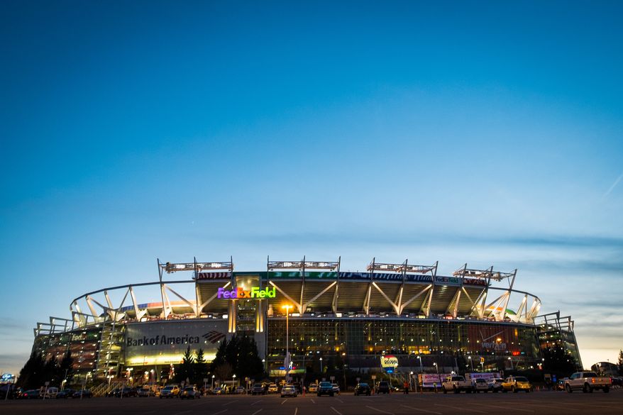 FedEx Field is lit up as fans arrive before the NFL football game between the Washington Redskins and the San Francisco 49ers in Landover, Monday, Nov. 25, 2013. (AP Photo/J. David Ake)