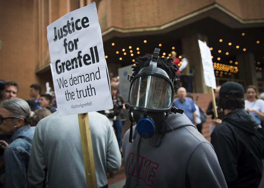 People protest ahead of a meeting of Kensington and Chelsea Council at Kensington Town Hall in west London, Wednesday July 19, 2017, the local authority in control of response to the recent Grenfell Tower fire. The fire at the Grenfell Tower residential bloc left dozens dead (Ben Stevens/PA via AP)