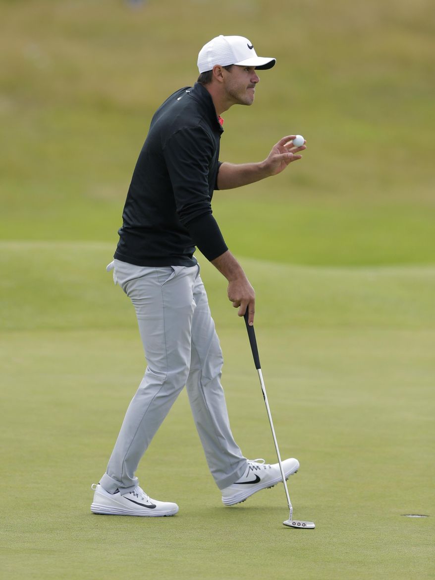 Brooks Koepka of the United States acknowledges the crowd on the 18th green after finishing his round on the first day of the British Open Golf Championship, at Royal Birkdale, Southport, England Thursday, July 20, 2017. (AP Photo/Alastair Grant)