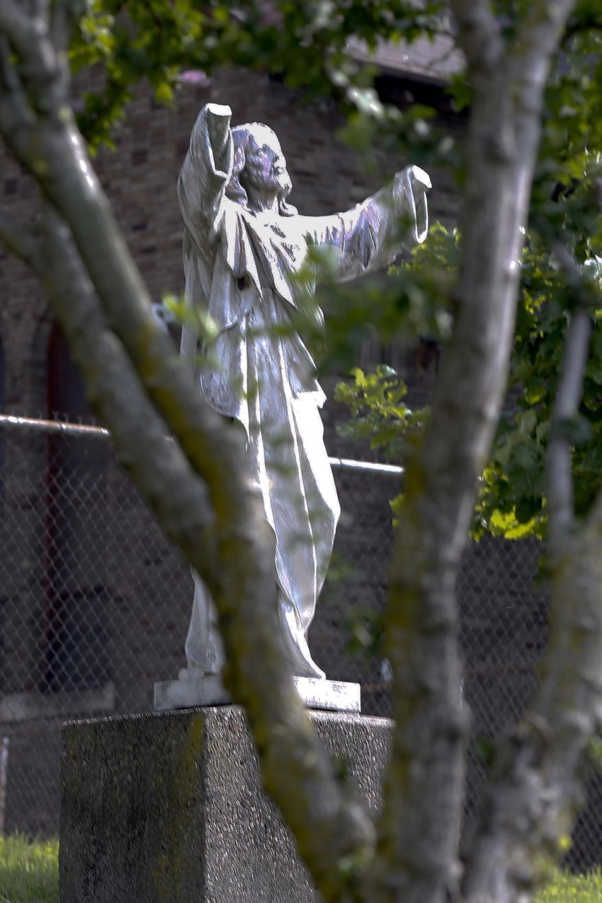 A vandelized statue of Jesus on the campus of Carlow University, a private Catholic university, is shown on Thursday, July 20, 2017, in Pittsburgh. School officials announced the vandalism on Wednesday, but said it was unclear exactly when it occurred. Authorities are hoping surveillance video identifies whoever broke the hands off a granite statue. (AP Photo/Keith Srakocic)
