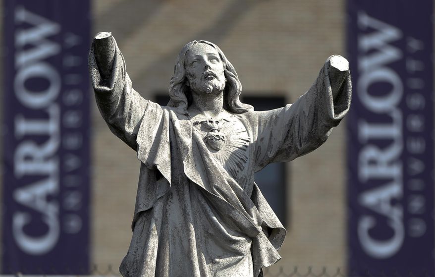 A vandelized statue of Jesus on the campus of Carlow University, a private Catholic university, is shown on Thursday, July 20, 2017, in Pittsburgh. School officials announced the vandalism on Wednesday, but said it was unclear exactly when it occurred. Authorities are hoping surveillance video identifies whoever broke the hands off a granite statue. (AP Photo/Keith Srakocic)