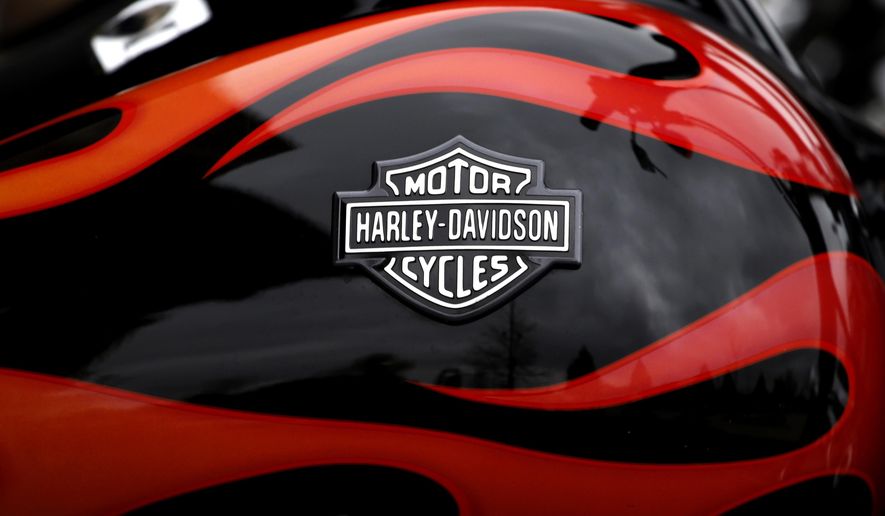 FILE - In this April 27, 2017, file photo, the Harley-Davidson name is seen on the gas tank of a motorcycle in Northbrook, Ill. The Justice Department is seeking to waive part of the penalty Harley Davidson Inc. agreed to pay in 2016 to settle a case over air pollution involving racing tuners that caused its motorcycles to emit higher-than-allowed pollution levels.The Justice Department on July 20, 2017, filed a new consent decree with the U.S. District Court for the District of Columbia. It eliminates a requirement that the Milwaukee-based company spend $3 million to curb air pollution in local communities by paying to replace conventional woodstoves with cleaner-burning versions. (AP Photo/Nam Y. Huh, File)