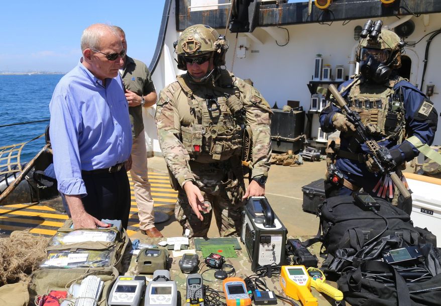 U.S. Homeland Security Secretary John Kelly speaks with a Coast Guardsman from the military branch’s new California-based Maritime Safety and Security Team after viewing a training demonstration aboard the Coast Guard Cutter Aspen on Thursday, July 20, 2017. (AP Photo/Mike Balsamo)