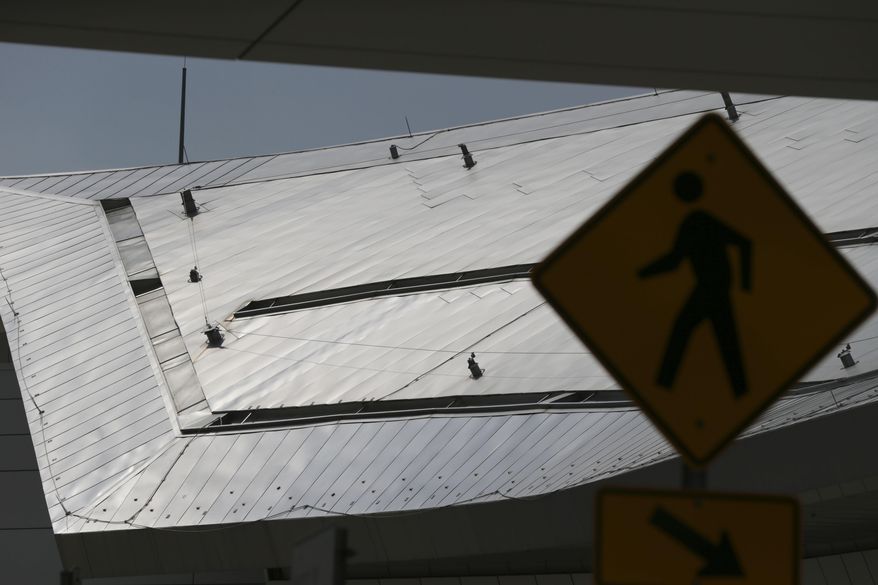 In this Tuesday, June 27, 2017 photo, a steel like material comprises the cover of terminal D at Dallas/Fort Worth International Airport in Grapevine, Texas. The steel style roof of the terminal was built using a cladding product that is believed to have been a major contributor to the London apartment tower fire. In sales brochures, a U.S. company boasted of the “stunning visual effect” its shimmering aluminum panels created in an NFL stadium, an Alaskan school and a 33-story hotel on Baltimore’s waterfront. Those same panels also were used in London’s Grenfell Tower. (AP Photo/LM Otero)