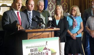 Wisconsin state Rep. Adam Jarchow, left, along with state Sen. Tom Tiffany, second from left, speak in support of their bill that would allow people to sell lots adjacent to lots they already own at a news conference Thursday, July 20, 2017, in Madison, Wisconsin. The U.S. Supreme Court ruled in June that a Wisconsin family couldn&#39;t sell their lot adjacent to their northwestern Wisconsin cabin. (AP Photo/Scott Bauer)