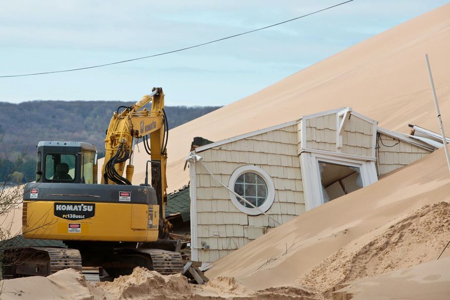 A home in the 1900 block of Shore Drive in Mears, Mich. is where one of two cottages on the property was swallowed by Silver Lake State Park sand dunes on April 28, 2017. (Joel Bissell/Muskegon Chronicle via AP)