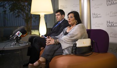 In this photo taken on Wednesday, July 19, 2017, Pilar Abel, right, talks to journalists next to her lawyer Enrique Blanquez during a news conference in Madrid, where she claimed to be the daughter of eccentric artist Salvador Dali.  61-year old Abel claims that her mother had an affair with Salvador Dali while working as a domestic helper in the northeastern Spanish town of Figueres, where the artist was born and lived with his Russian wife Gala.  After two decades of court battles, a Madrid judge granted Abel a DNA test to find out whether her allegations are true, and the exhumation is scheduled to begin Thursday night.(AP Photo/Francisco Seco)