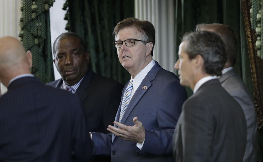 Lt. Gov. Dan Patrick, center, talks with state senators on the second day of a special session ordered by Republican Gov. Greg Abbott, in Austin, Texas, Wednesday, July 19, 2017. Conservatives in the state Senate are swiftly advancing sunset legislation, a regulatory bill that must pass before the legislature can work on anti-abortion measures, school vouchers and defanging local ordinances in Texas' big and liberal cities. (AP Photo/Eric Gay)
