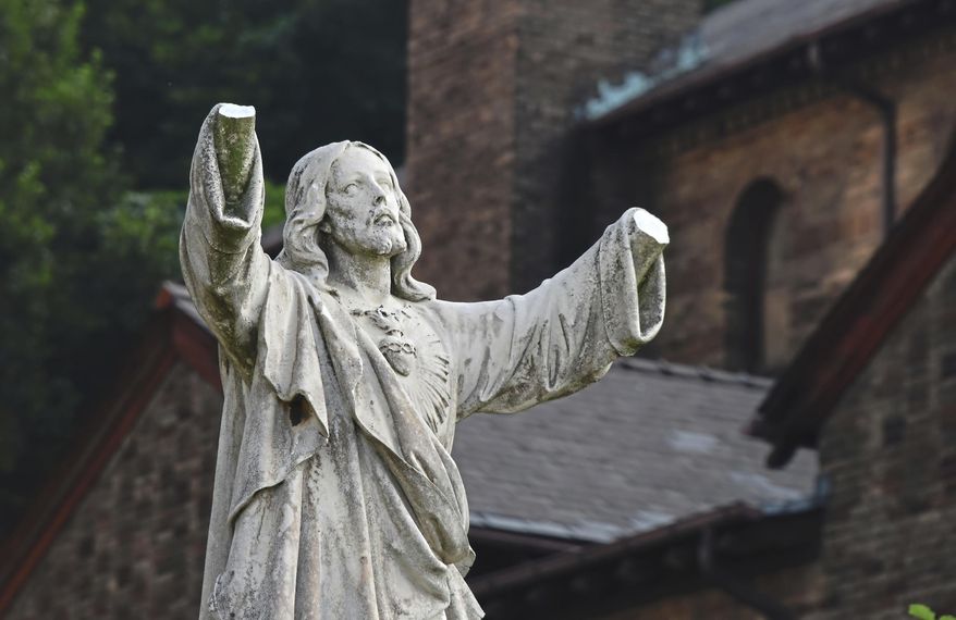 A statue of Jesus was vandalized on the campus of Carlow University, in the Oakland section of Pittsburgh, Thursday July 20, 2017. Officials at Carlow University are investigating who might have broken off the hands of the statue of Jesus on their Oakland campus. (Darrell Sapp/Pittsburgh Post-Gazette via AP)