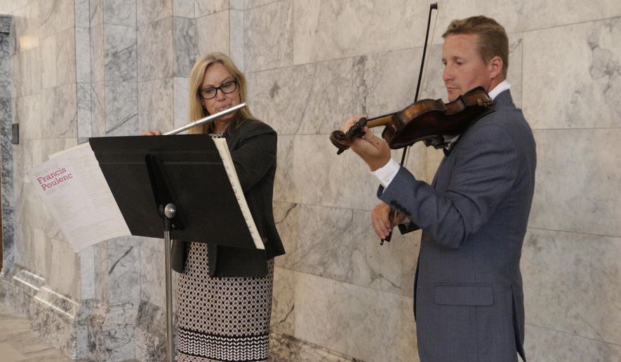 Republican Reps. Mary Dye and Vincent Buys play music in the Capitol Rotunda on the last day of the third special session, Thursday, July 20, 2017, in Olympia, Wash. Lawmakers have been in session for more than 190 days this year as they've struggled to reach agreement on several issues. (AP Photo/Rachel La Corte)