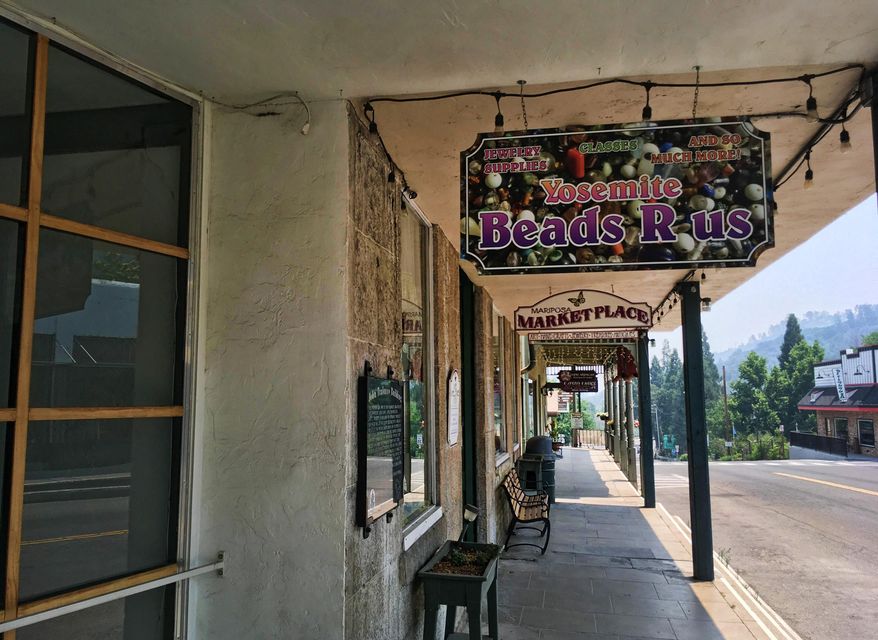 The evacuated downtown of Mariposa, Calif., is viewed Thursday, July 20, 2017, as firefighters battle a large wildfire in the surrounding hills and mountains. Mariposa normally bustles with tourists on their way to Yosemite National Park. The town's center is made up of old brick and wooden buildings in the holding modern clothing and gift shops, restaurants and wine bars. (AP Photo/Scott Smith)