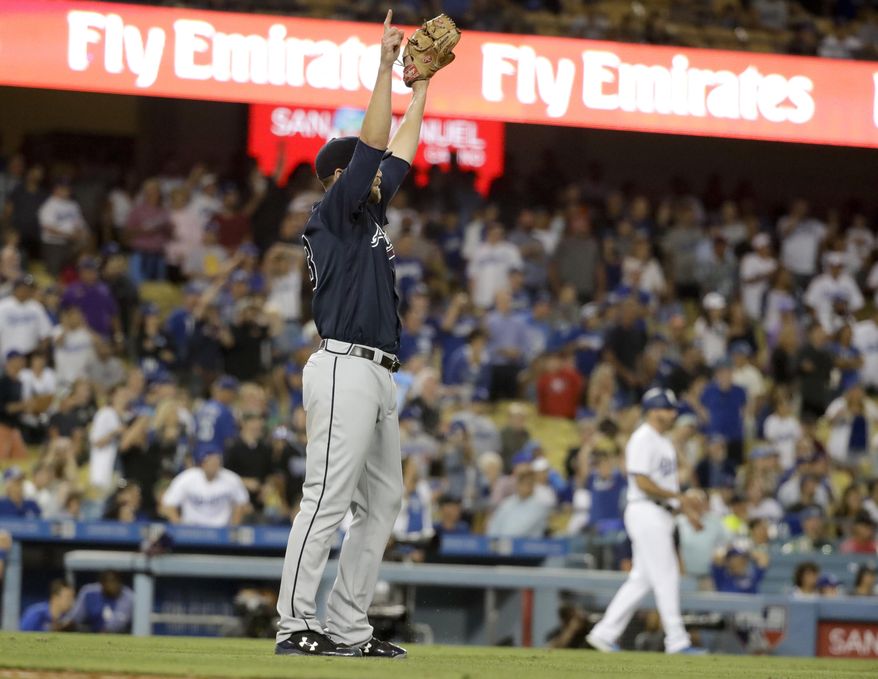 Atlanta Braves relief pitcher Jim Johnson celebrates after the team's 6-3 win over the Los Angeles Dodgers in a baseball game in Los Angeles, Thursday, July 20, 2017. (AP Photo/Chris Carlson)