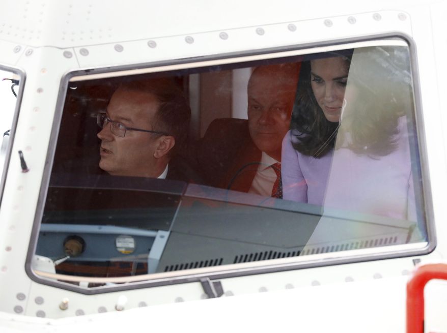 Britain&#x27;s Kate, the Duchess of Cambridge, right,  and  Assembly Line Vice President Olaf Lawrenz, left, sit  in the cockpit of an A320 plane during the visit of Britain&#x27;s Prince William and his wife to  Airbus, in Hamburg, Germany, Friday, July 21, 2017.  In center Hamburg&#x27;s mayor Olaf Scholz. (Georg Wendt/dpa via AP)
