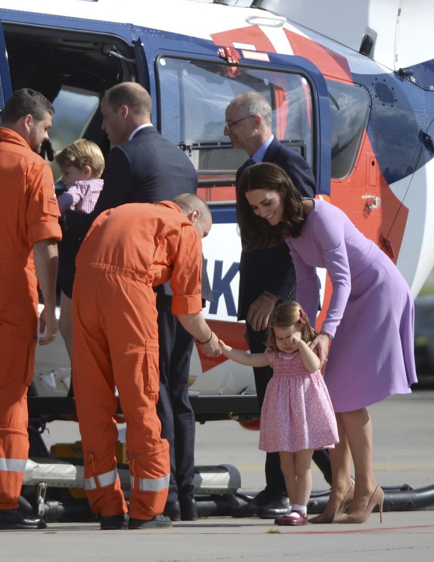 Britain&#39;s  Prince William and Kate the Duchess of Cambridge, right, and their children Charlotte,  second right and George, second left,  inspect  a helicopter during their visit to Airbus in Hamburg, Germany, Friday, July 21, 2017.  (Christina Sabrowsky/dpa via AP)
