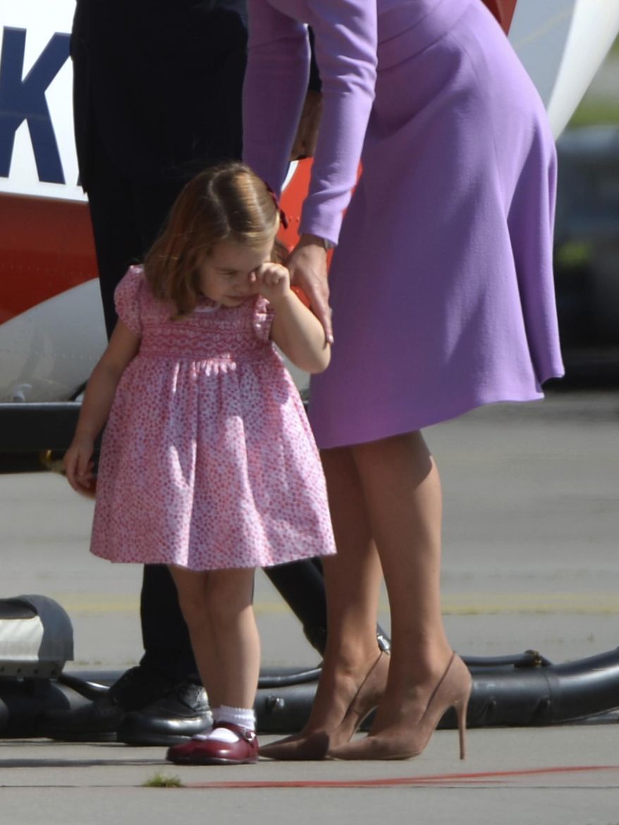 Britain&#39;s  Kate, the Duchess of Cambridge  looks at an Airbus helicopter with her daughter Princess Charlotte  during the visit to Airbus in Hamburg, Germany, Friday, July 21, 2017. Hamburg is the last leg of the royal couple&#39;s Germany visit. (Christina Sabrowska/dpa via AP)
