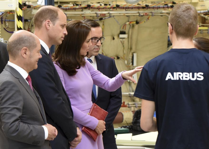 From left: Hamburg&#39;s Mayor Olaf Scholz, Britain&#39;s Prince William and his wife Kate, the Duchess of Cambridge visit the Airbus production of the A320 in Hamburg-Finkenwerder, Friday, July 21, 2017. (Daniel Bockwoldt/Pool Photo via AP)
