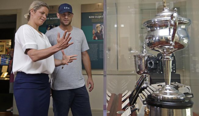 Tennis stars Kim Clijsters of Belgium and Andy Roddick of the USA chat about their trophies displayed at the International Hall of Fame Tennis Museum, Friday, July 21, 2017, in Newport, R.I. They will be inducted into the Hall of Fame during enshrinement ceremonies on Saturday. (AP Photo/Elise Amendola)