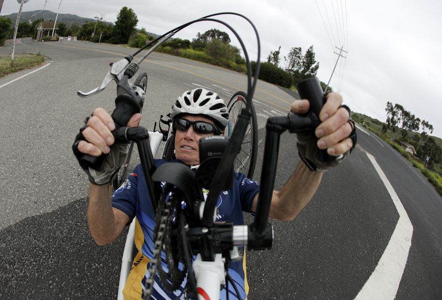 In this Thursday, June 8, 2017 photo, Beth Sanden trains for a marathon on her hand cycle in San Clemente, Calif. During a bike training accident for an Ironman competition Sanden became partially paralyzed and now helps other triathletes with similar injuries train. (AP Photo/Chris Carlson)