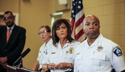 Minneapolis police chief Janee Harteau, center, stands with police inspector Kathy Waite, left, and assistant chief Medaria Arradondo during a news conference Thursday, July 20, 2017, Minneapolis. The family of an Australian woman shot dead by a Minneapolis police officer wants changes in police protocols, including a look at how often officers are required to turn on their body cameras, a family attorney told local media. (Maria Alejandra Cardona/Minnesota Public Radio via AP)